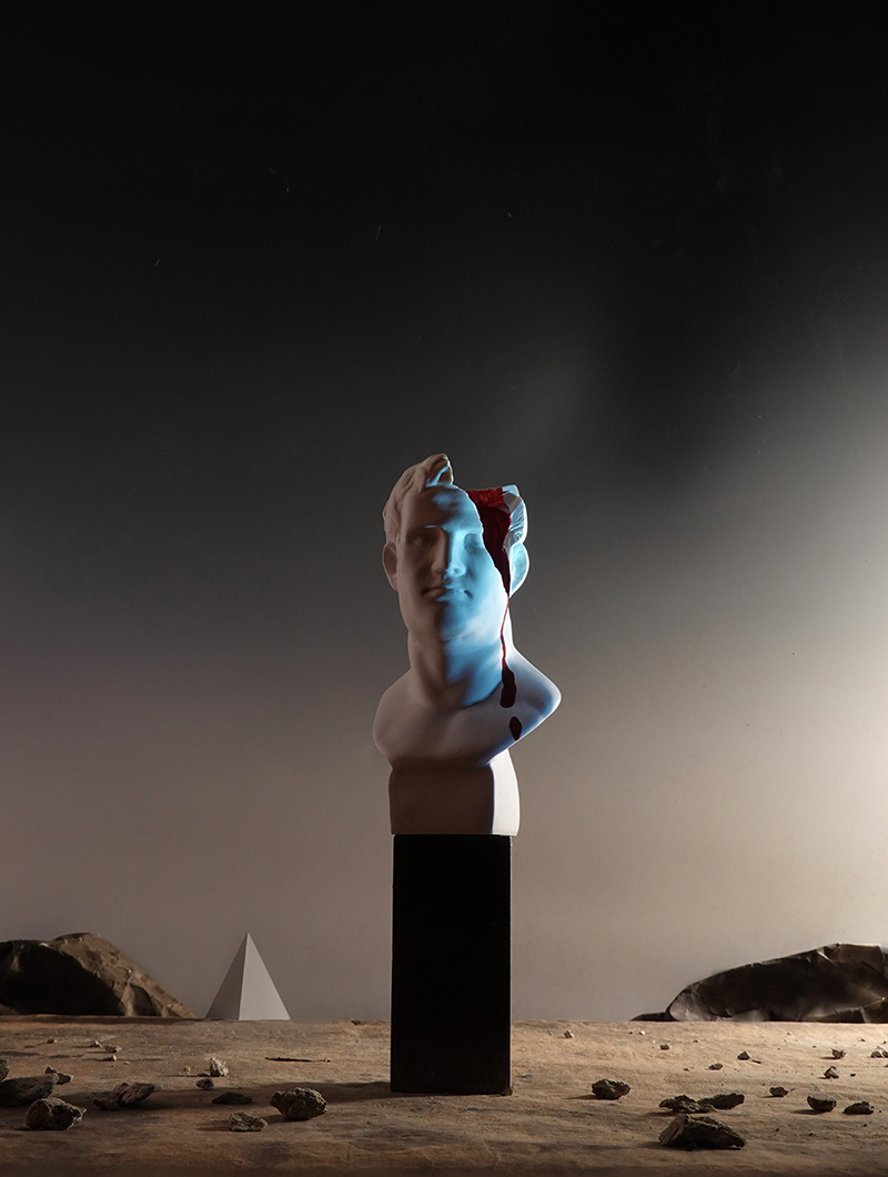 surrealism, dream, roman emperor head, statue, broken statue, bleeding head, wounded, pyramid, landscape